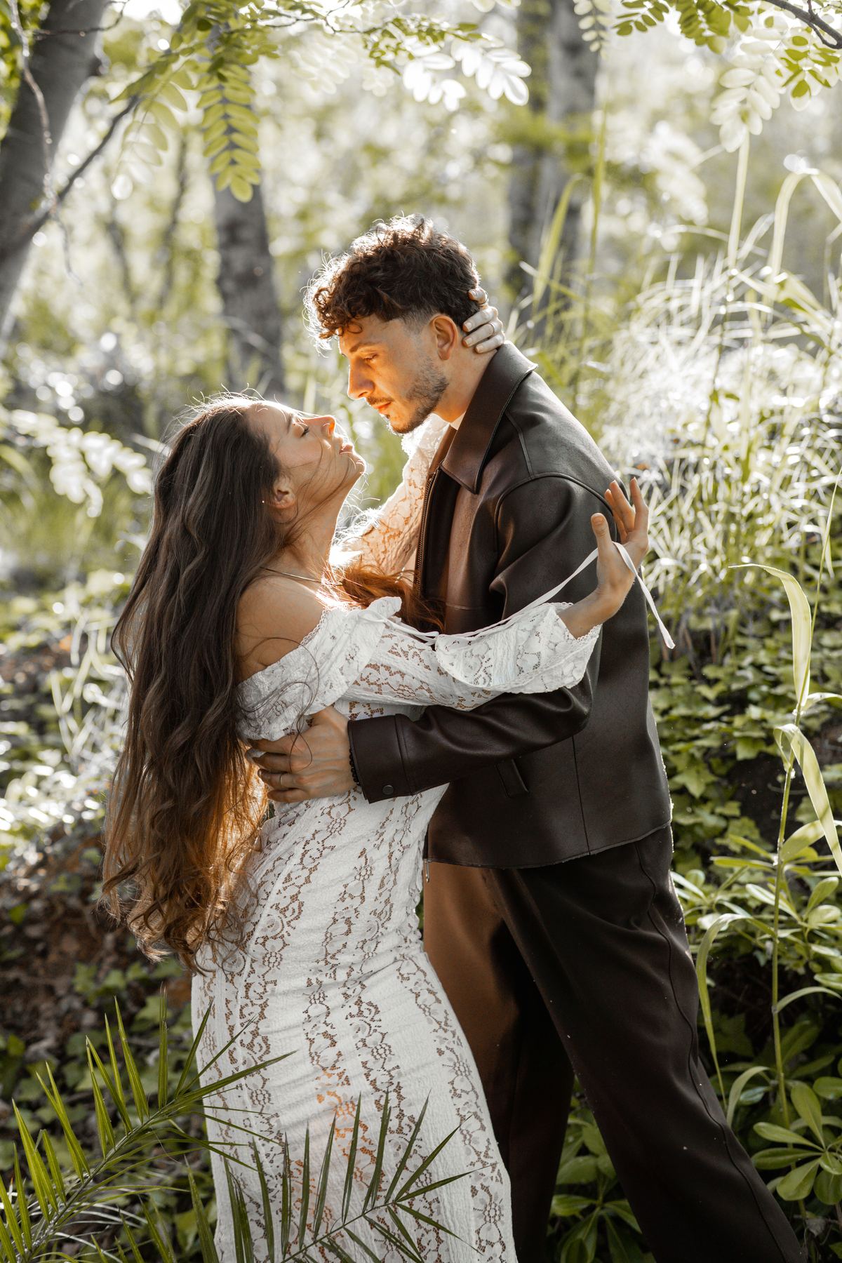 Michael and Mayra together in a sunlit forest