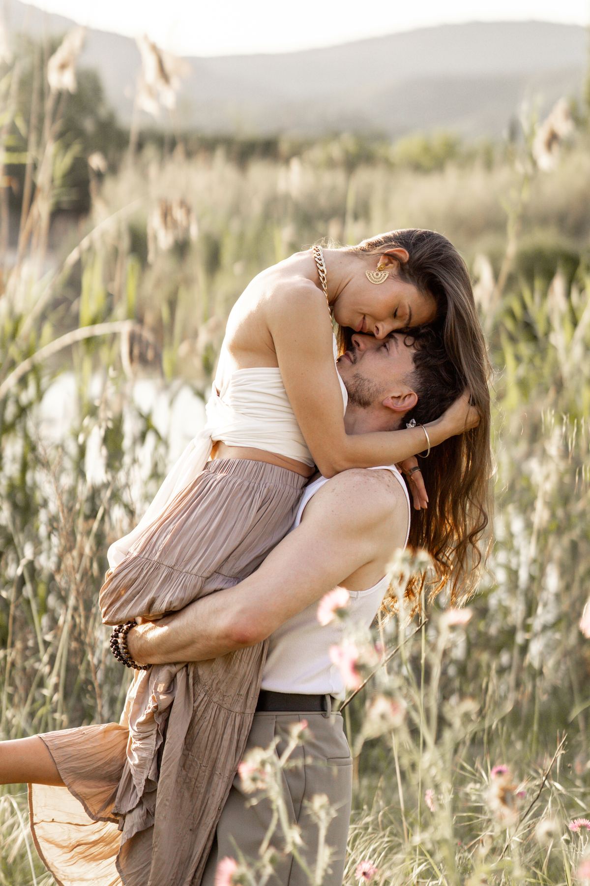 Michael and Mayra in an open field at golden hour